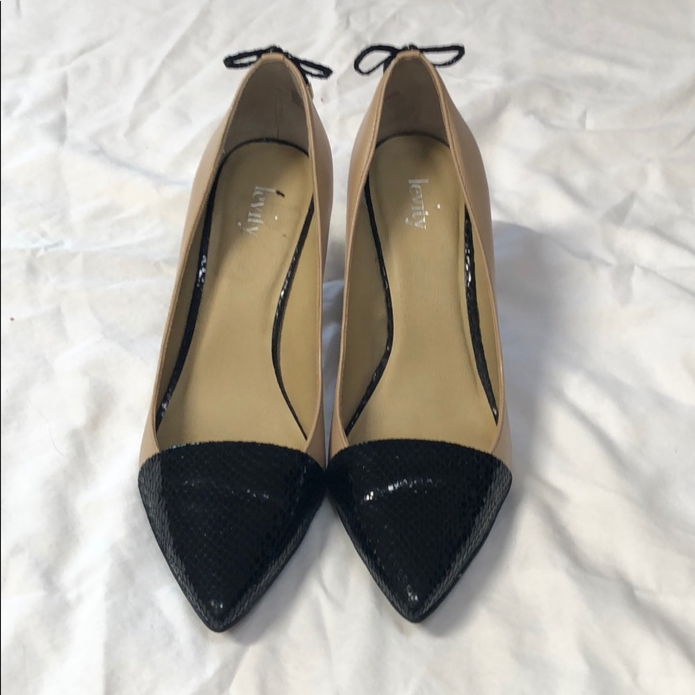 Nude pumps with black snakeskin toes